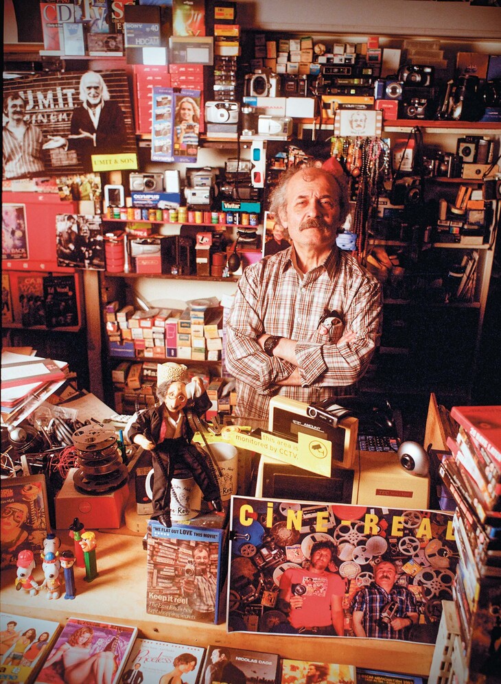 A man surrounded by cine paraphernalia