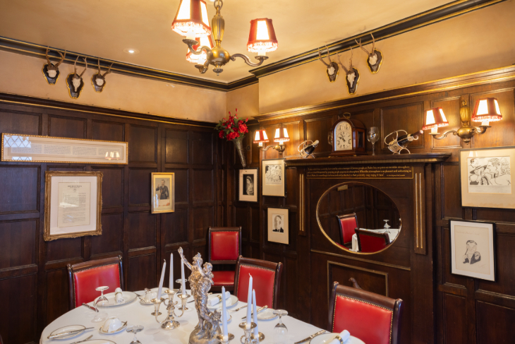 A dark wood panelled dining room