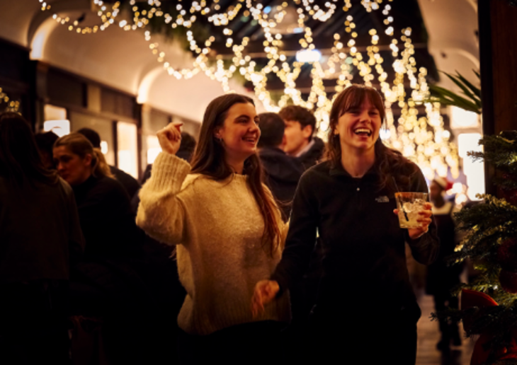 Christmas light switch ons 2026: two women beneath Christmas lights