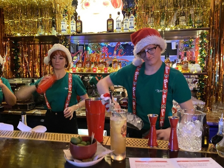People mixing drinks in a festive setting
