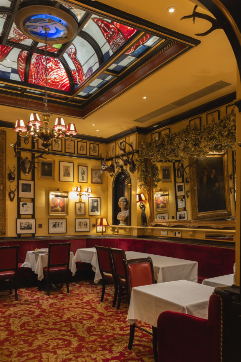 The interior of Rules, with a colourful glass dome in the ceiling