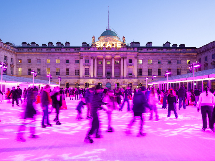 Things to do in London Christmas Eve 2026: people skating on a pink-lit ice rink at Somerset House at dusk