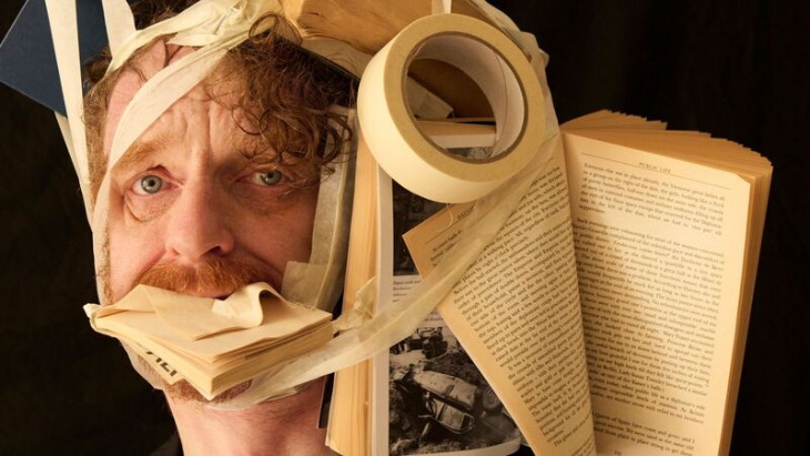 Things to do in London today: a man with masking tape wrapped around his head, taped to a book