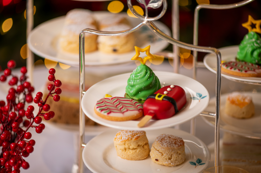 Best Christmas afternoon tea in London 2026: an afternoon tea stand topped with pastries decorated like Santa, a Christmas tree and a bauble