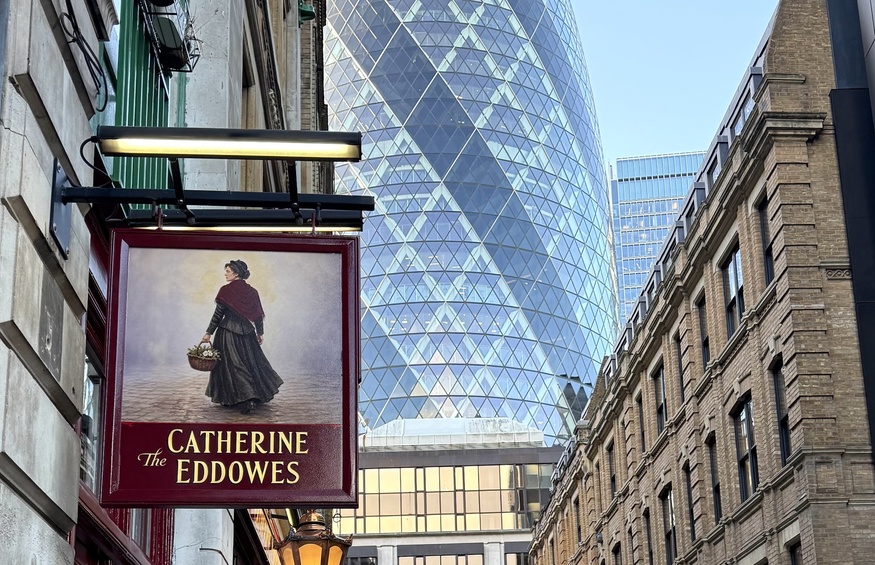 The pub sign in front of the Gherkin