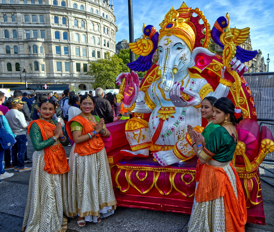 Free thinsg to do in London this week: a group of people in traditional Indian dress posing for a photo next to a statue of the elephant Hindu god Ganesh in Trafalgar Square