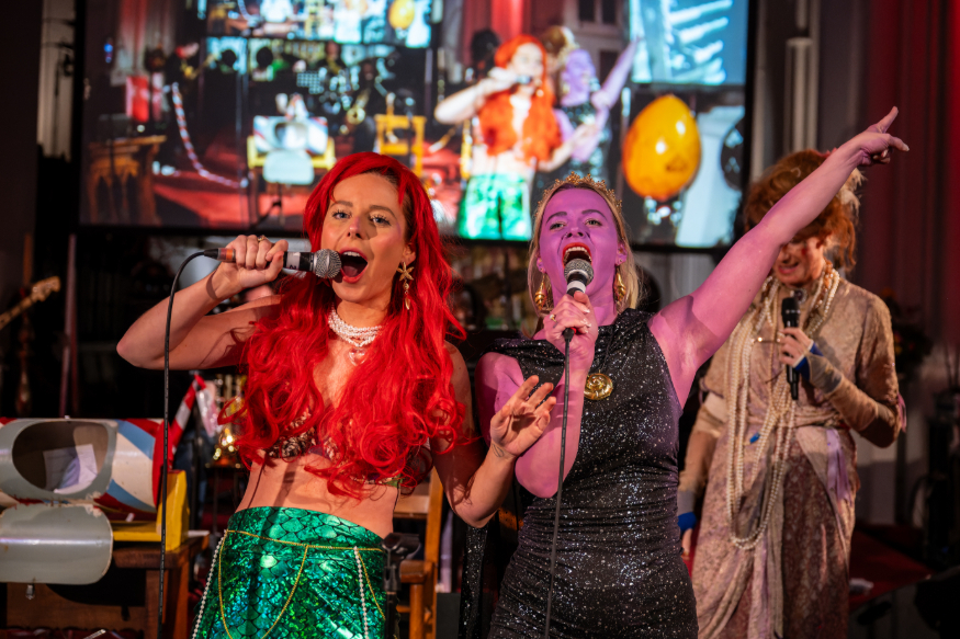 Things to do in London this weekend: two people doing karaoke in fancy dress