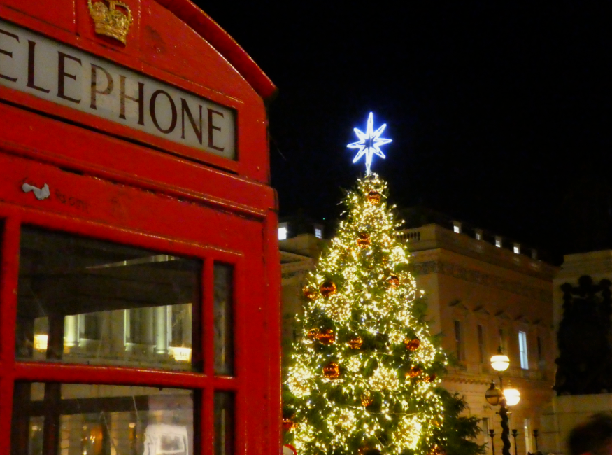 Christmas 2026 in London calendar: A glowing Christmas tree behind an iconic red phone box